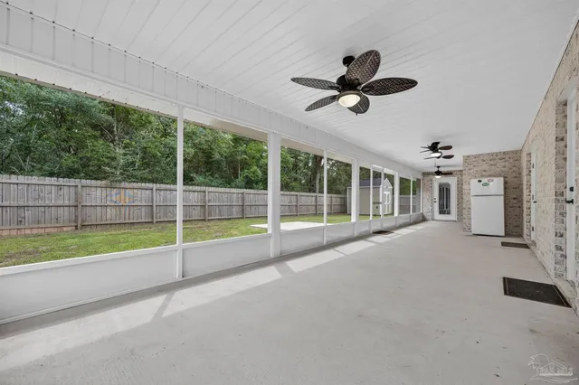 a view of an empty room with floor to ceiling windows