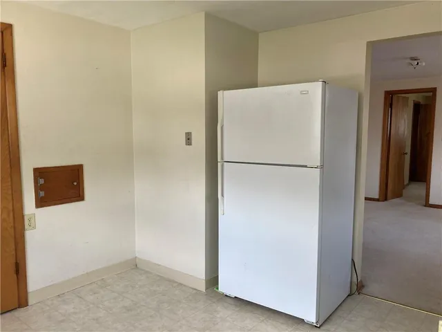 a white refrigerator freezer sitting in a kitchen