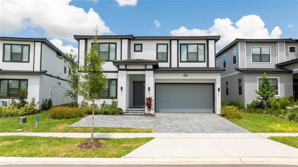 10018 Voyager Way Orlando, FL 32821 - Photo 1 of 100 a front view of a house with garden