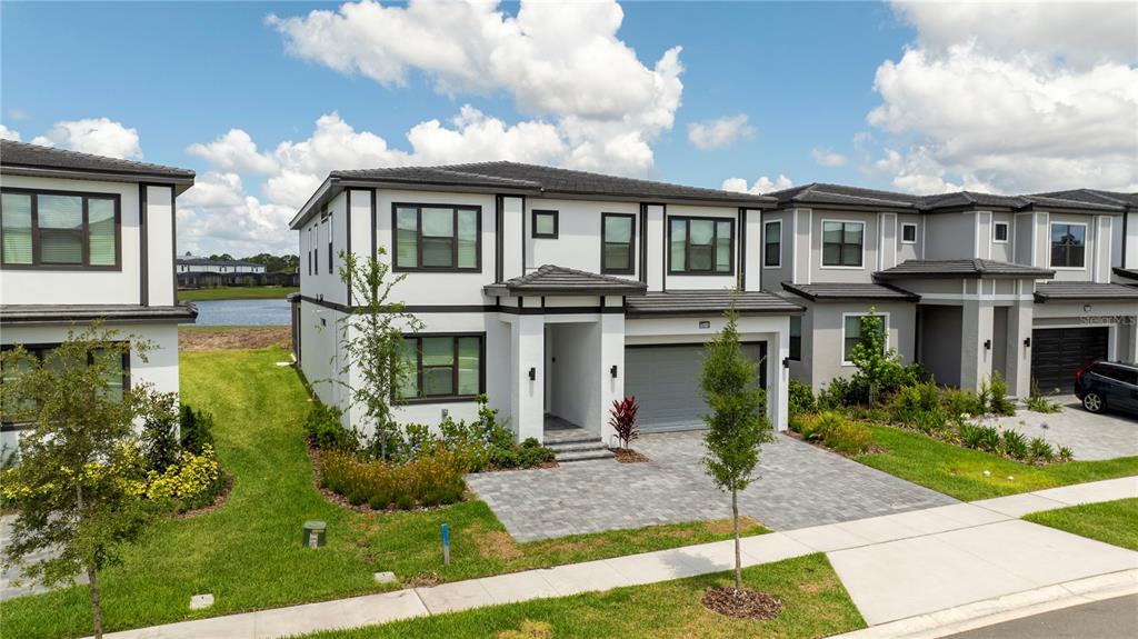 10018 Voyager Way Orlando, FL 32821 - Photo 2 of 100 a front view of a residential houses with yard