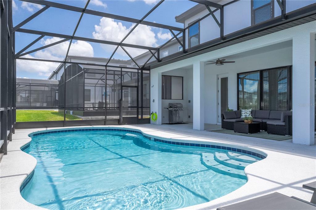 10018 Voyager Way Orlando, FL 32821 - Photo 38 of 100 a view of swimming pool with an outdoor seating