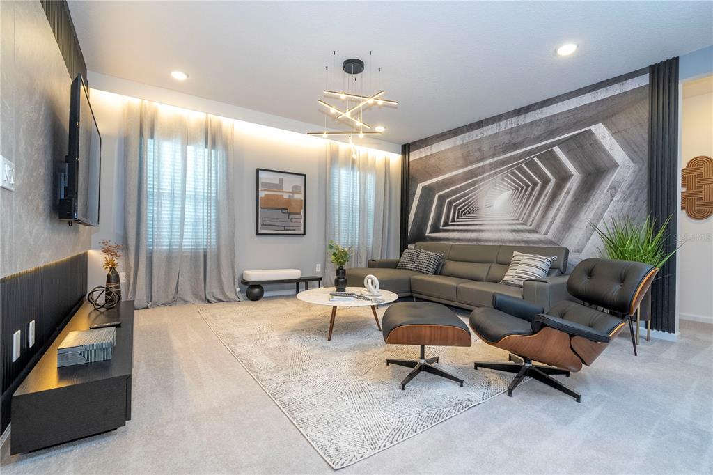 10018 Voyager Way Orlando, FL 32821 - Photo 45 of 100 a living room with furniture and a chandelier
