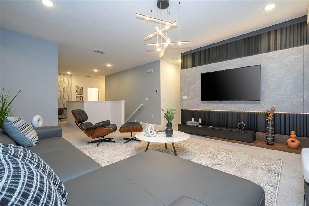 10018 Voyager Way Orlando, FL 32821 - Photo 48 of 100 a living room with furniture and a flat screen tv