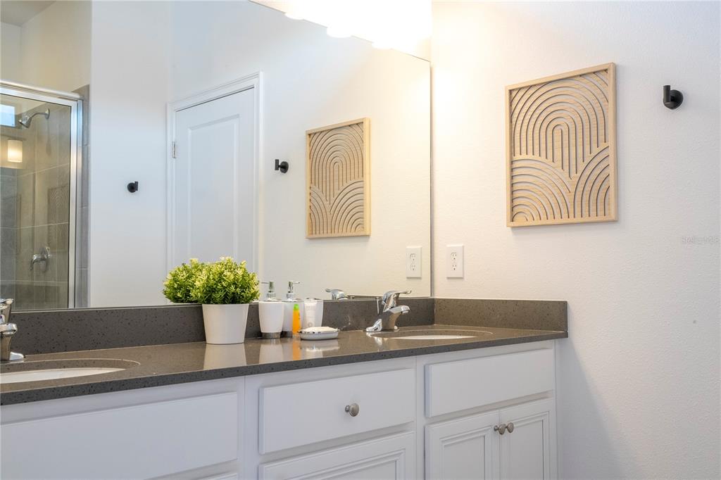 10018 Voyager Way Orlando, FL 32821 - Photo 52 of 100 a bathroom with a sink and a mirror