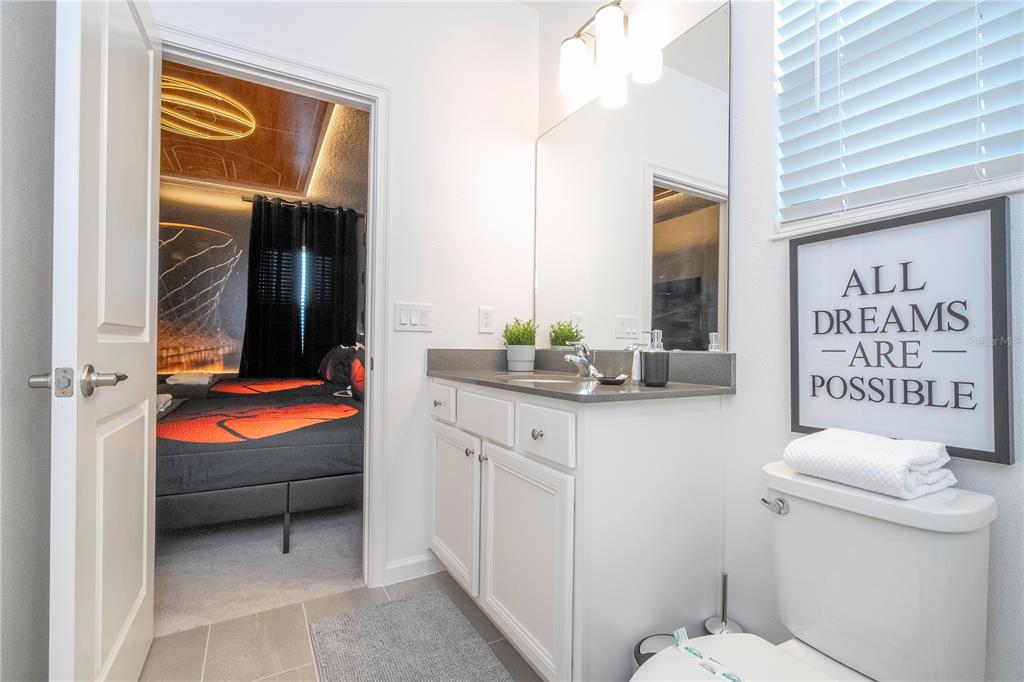 10018 Voyager Way Orlando, FL 32821 - Photo 65 of 100 a bathroom with a sink and a mirror
