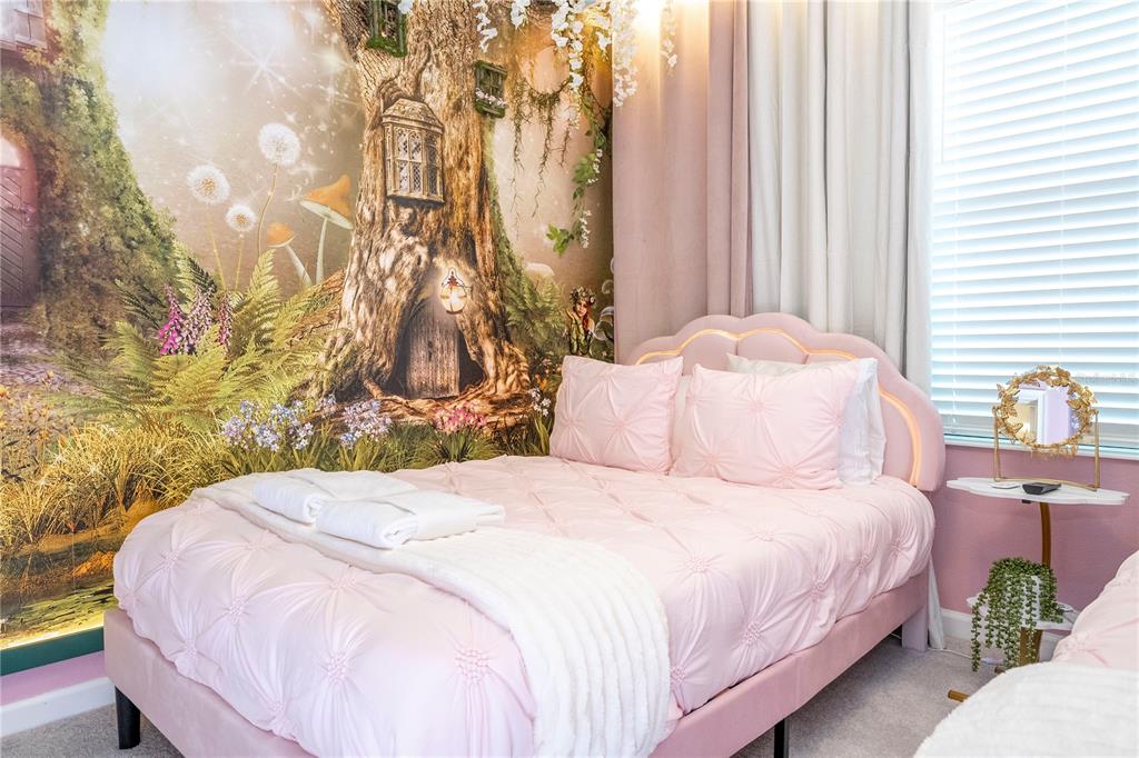 10018 Voyager Way Orlando, FL 32821 - Photo 69 of 100 a bedroom with a bed lamp and a large window