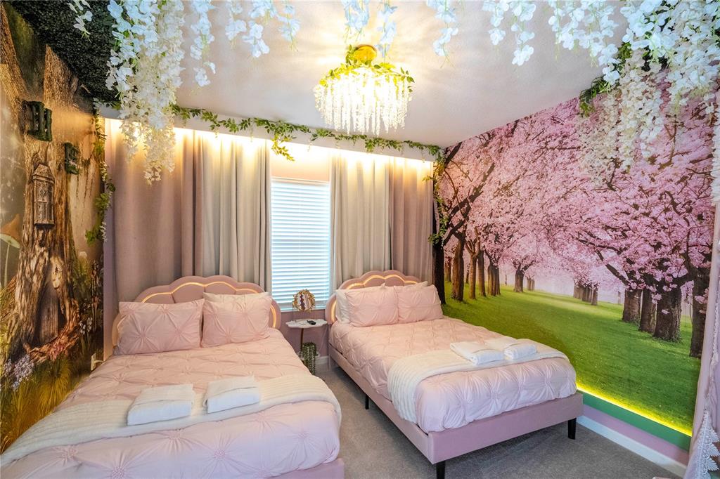10018 Voyager Way Orlando, FL 32821 - Photo 76 of 100 a bedroom with a bed and a chandelier