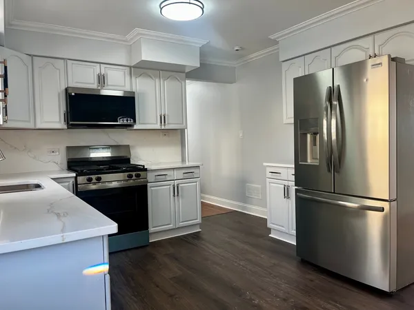 a kitchen with stainless steel appliances and wooden cabinets
