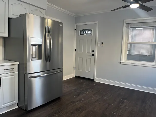 a metallic refrigerator freezer sitting in a kitchen