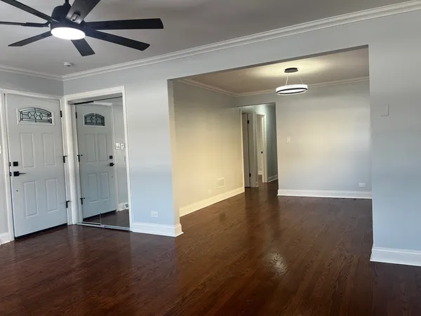a view of an empty room with wooden floor