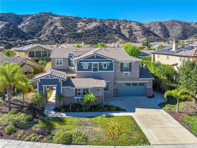 a front view of a house with a garden and plants