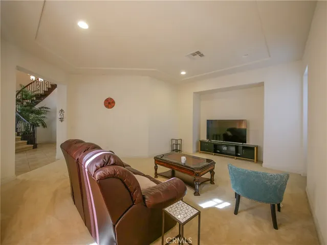 a dining room with furniture a chandelier and window