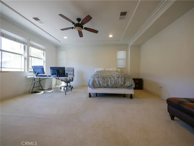 a bedroom with bed and a tv
