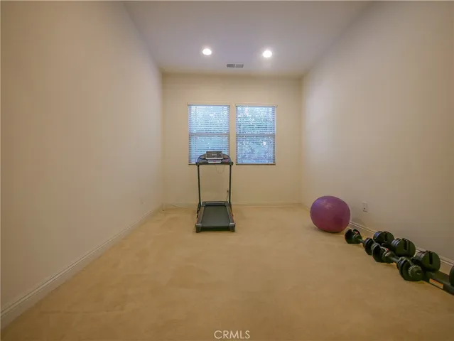 an empty room with windows and closet