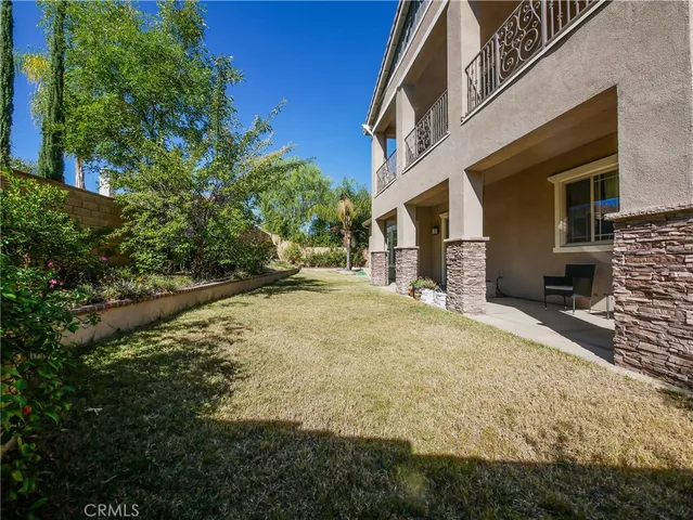 an aerial view of a house with outdoor space and a parking space