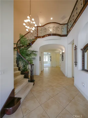 a view of a hallway with chandelier and entryway