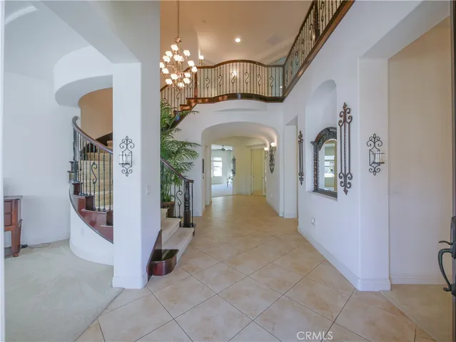 a lobby with furniture and potted plants