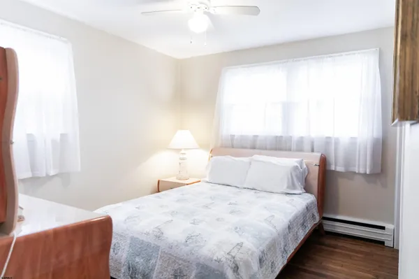 a bedroom with a bed and a painting on the wall