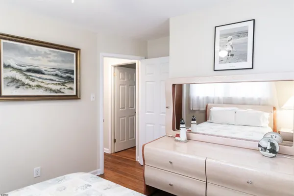 a bedroom with bed and desk