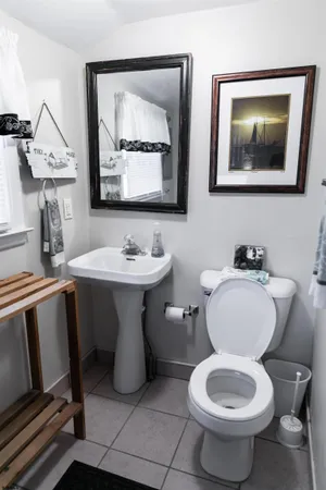 a utility room with dryer washer and a view of living room