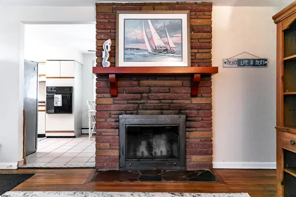 a living room with furniture a fireplace and a floor to ceiling window