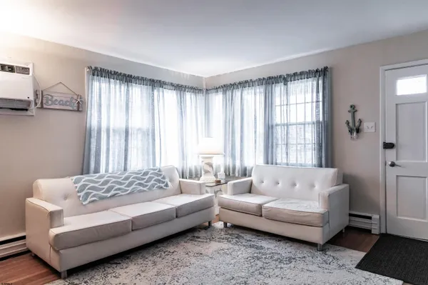 a living room with furniture window and wooden floor