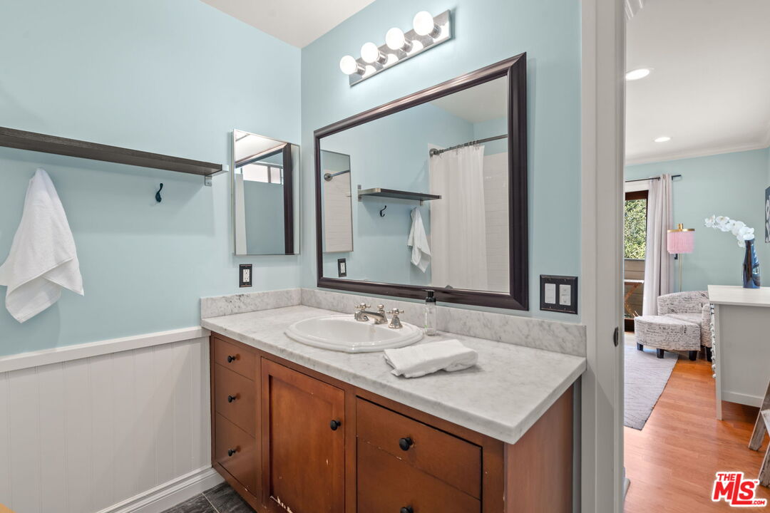 409 Adena Street, Unit 1 Pasadena, CA 91104 - Photo 16 of 26 a bathroom with a sink a vanity a mirror and a shower