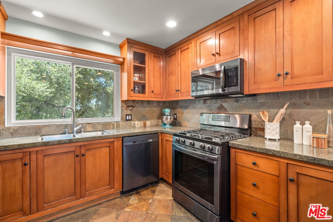 409 Adena Street, Unit 1 Pasadena, CA 91104 - Photo 9 of 26 a kitchen with stainless steel appliances granite countertop wooden cabinets and a stove top oven