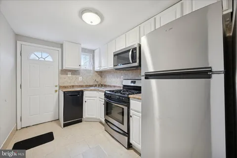 a kitchen with stainless steel appliances a refrigerator sink and stove