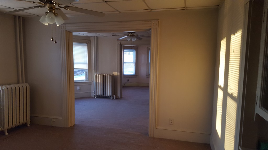 33 Cambridge Street Fall River, MA 02721 - Photo 2 of 10 a view of a hallway with wooden shelves
