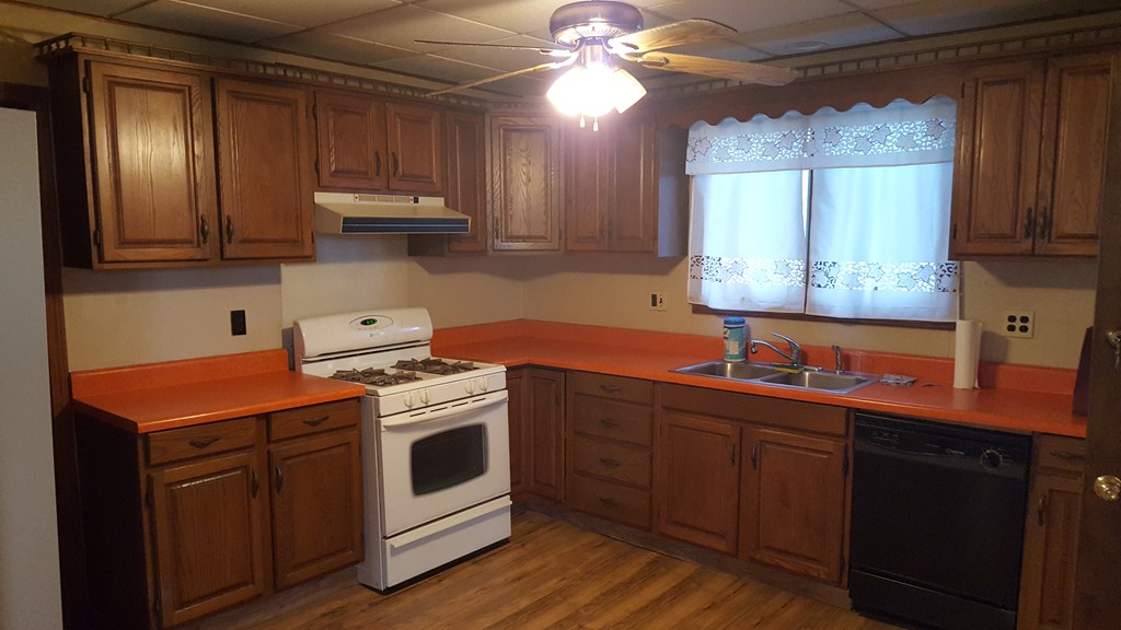 33 Cambridge Street Fall River, MA 02721 - Photo 4 of 10 a kitchen with stainless steel appliances granite countertop a sink a stove a refrigerator and cabinets