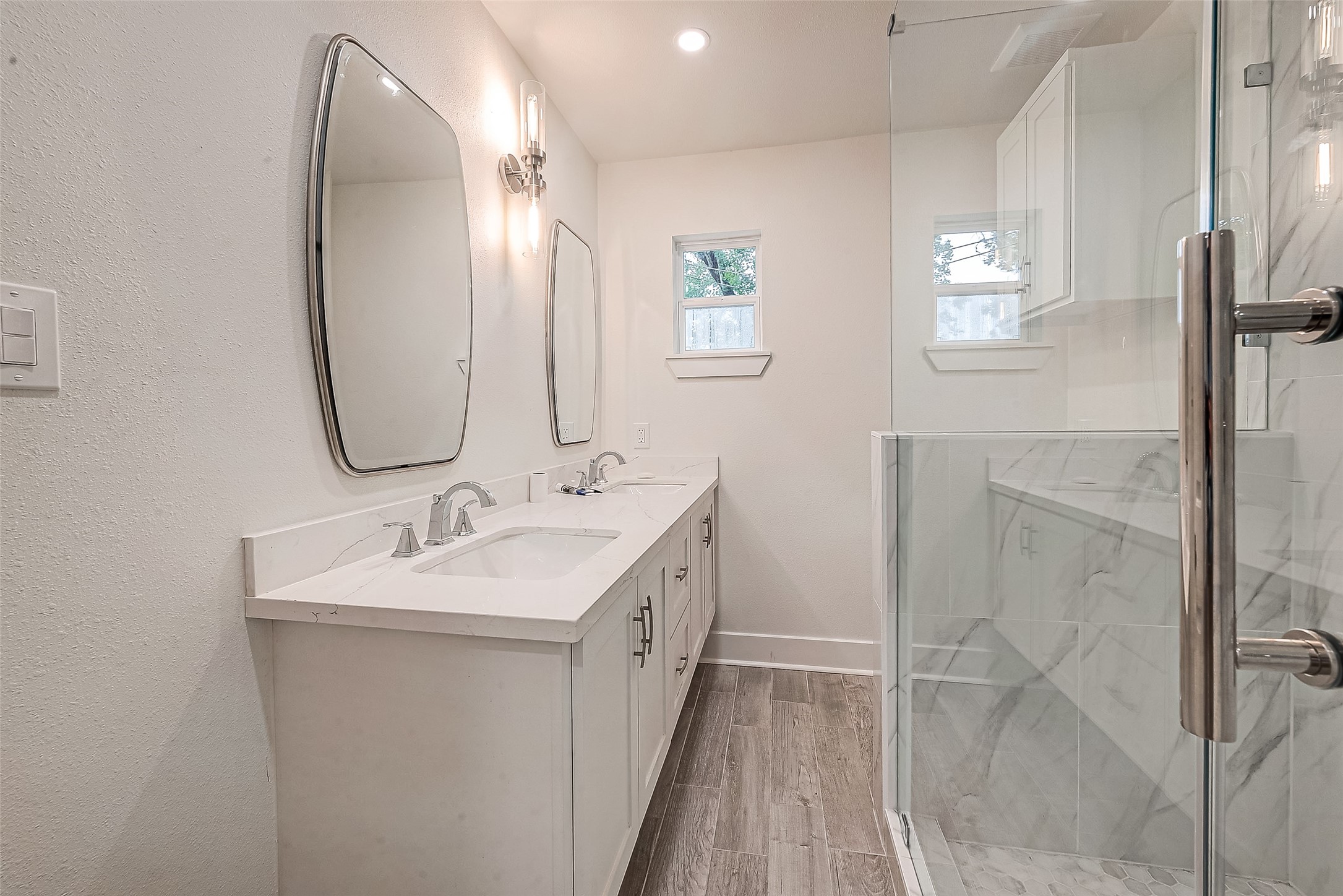 5703 Belmark Street Houston, TX 77033 - Photo 14 of 43 a bathroom with a double vanity sink and a mirror