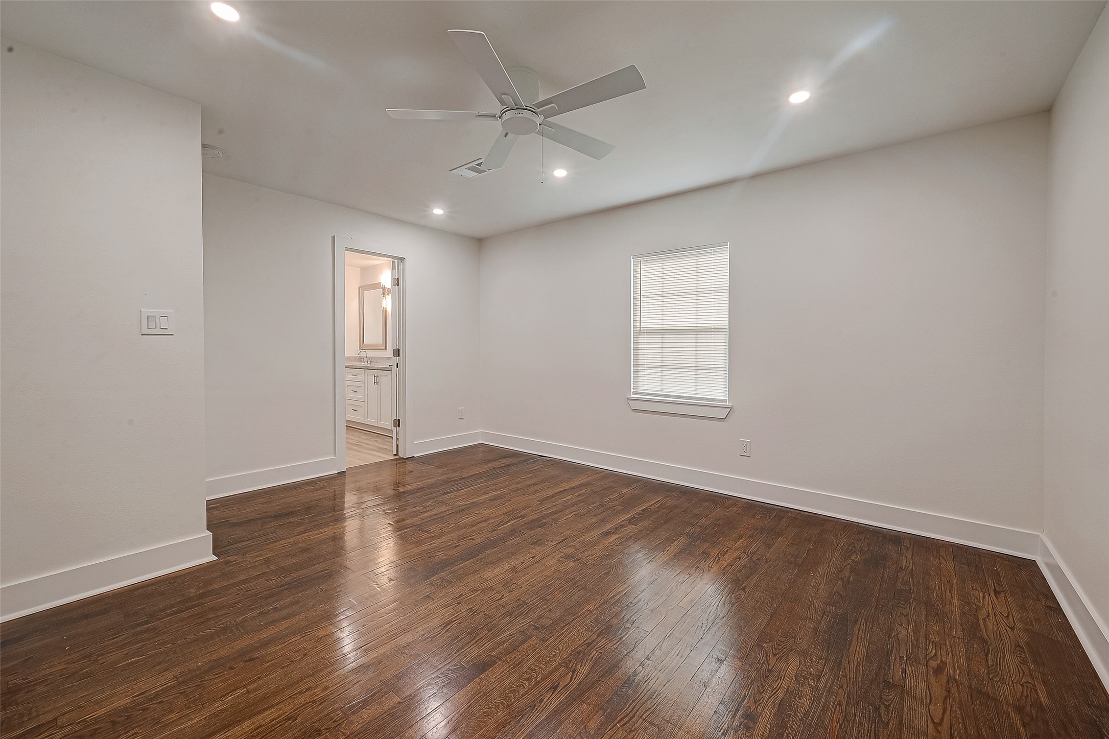5703 Belmark Street Houston, TX 77033 - Photo 16 of 43 an empty room with wooden floor and windows