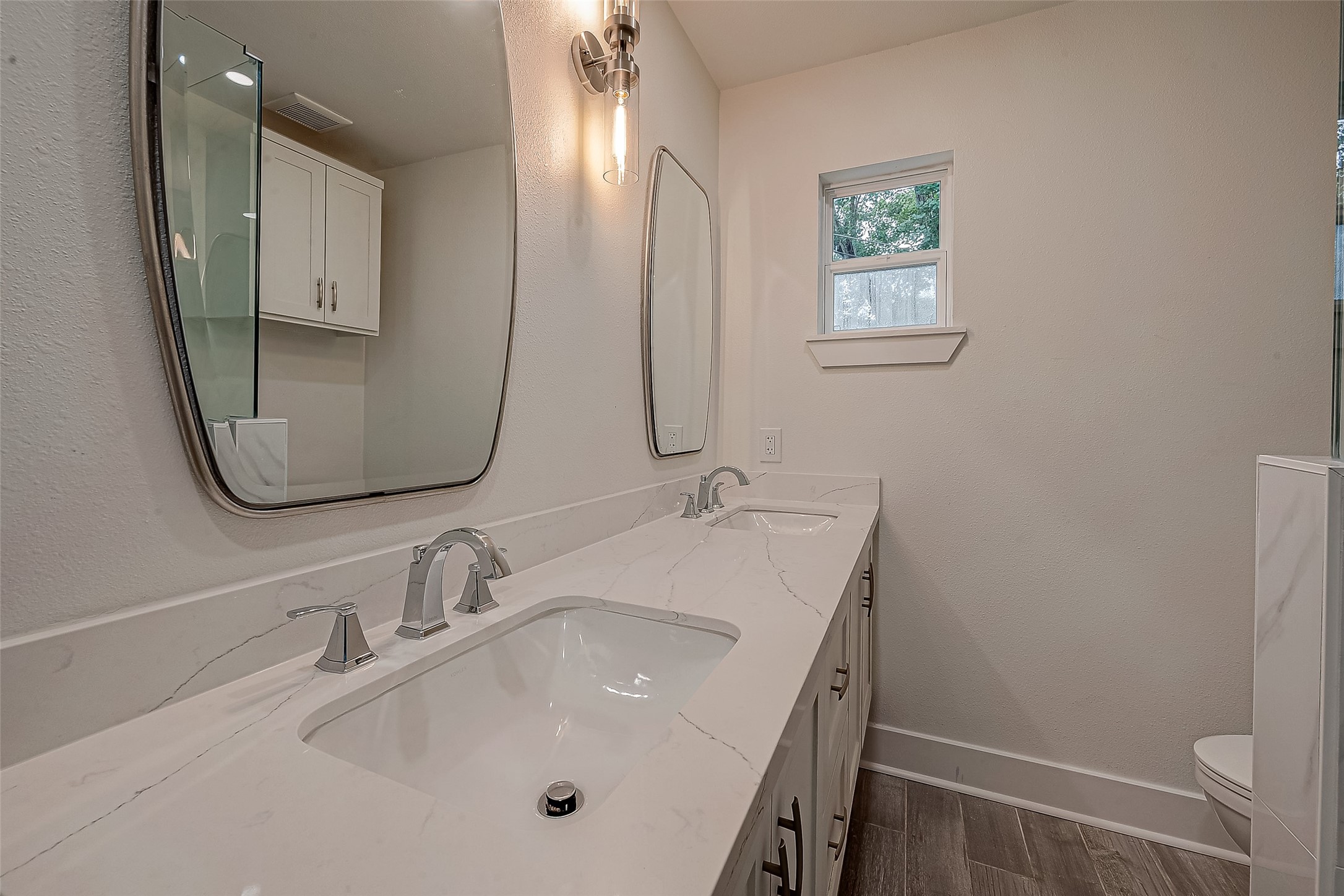 5703 Belmark Street Houston, TX 77033 - Photo 22 of 43 a bathroom with 2 sink and a mirror
