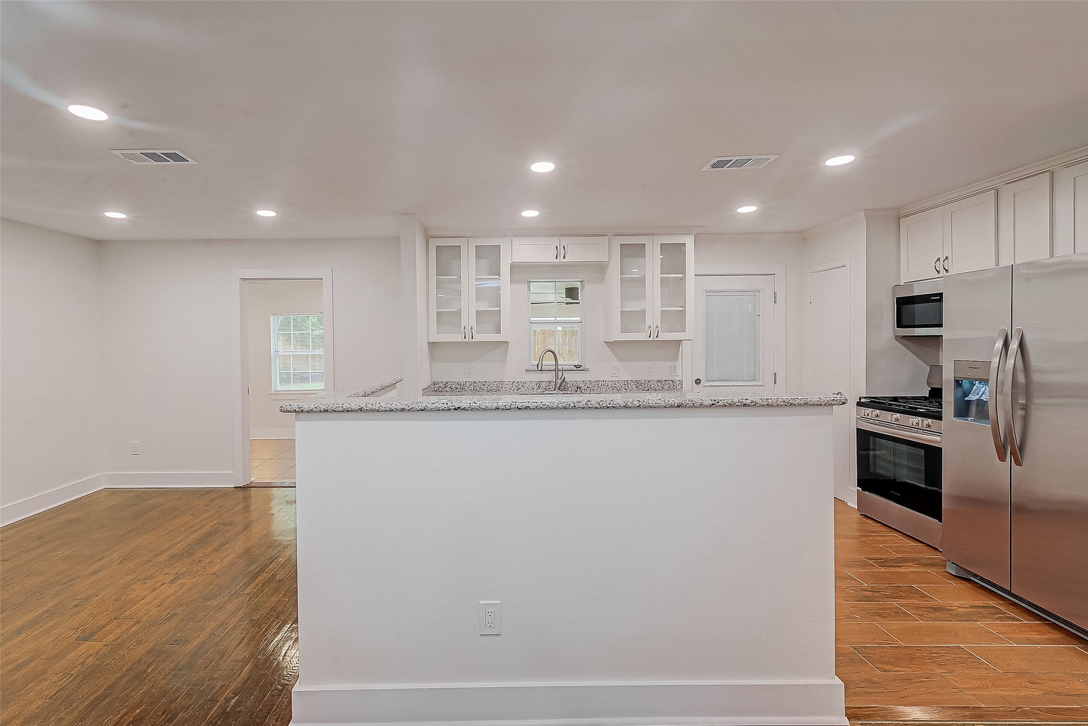 5703 Belmark Street Houston, TX 77033 - Photo 33 of 43 a large kitchen with granite countertop a large counter top stainless steel appliances and cabinets
