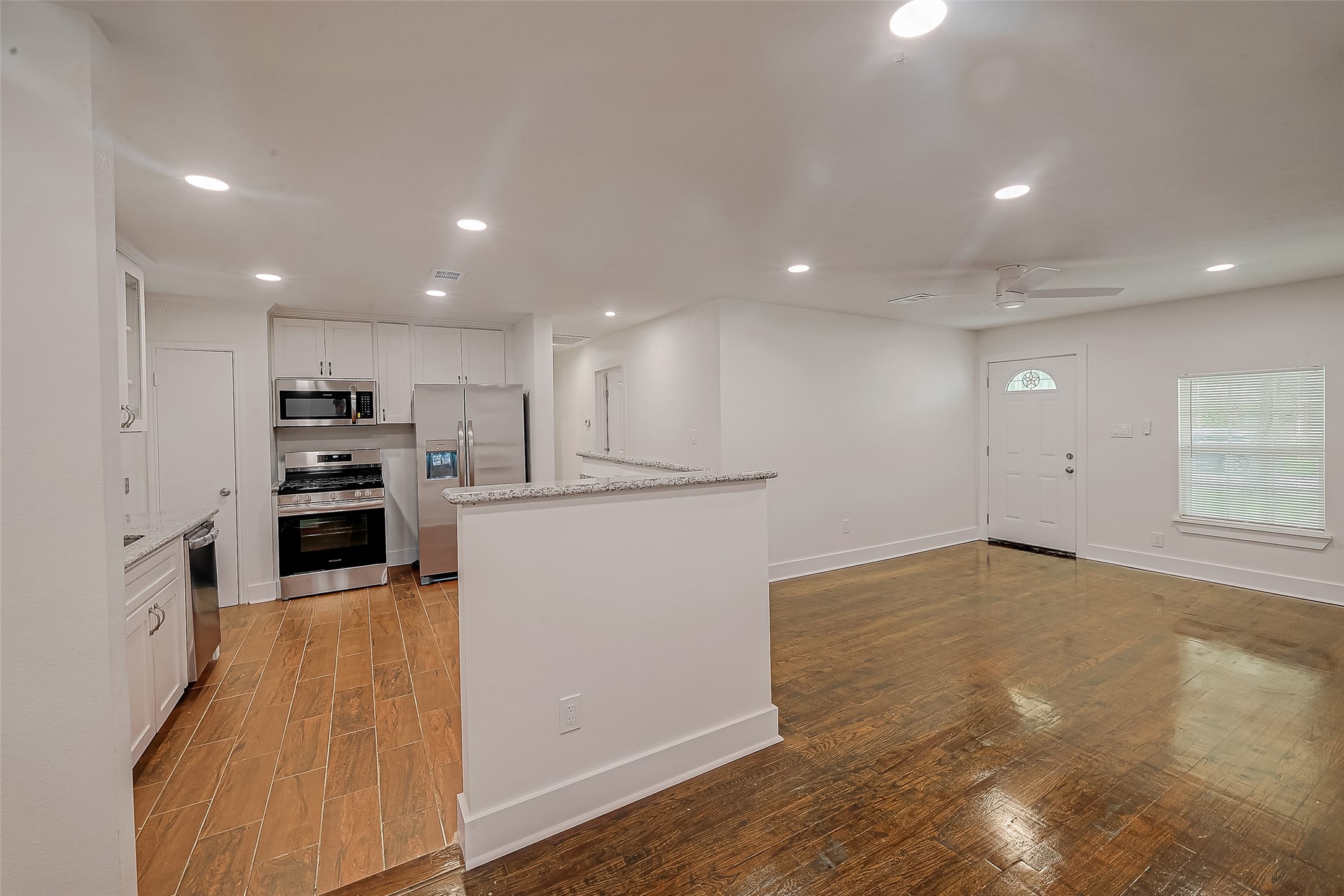 5703 Belmark Street Houston, TX 77033 - Photo 35 of 43 a view of a kitchen with a sink and dishwasher a refrigerator with wooden floor