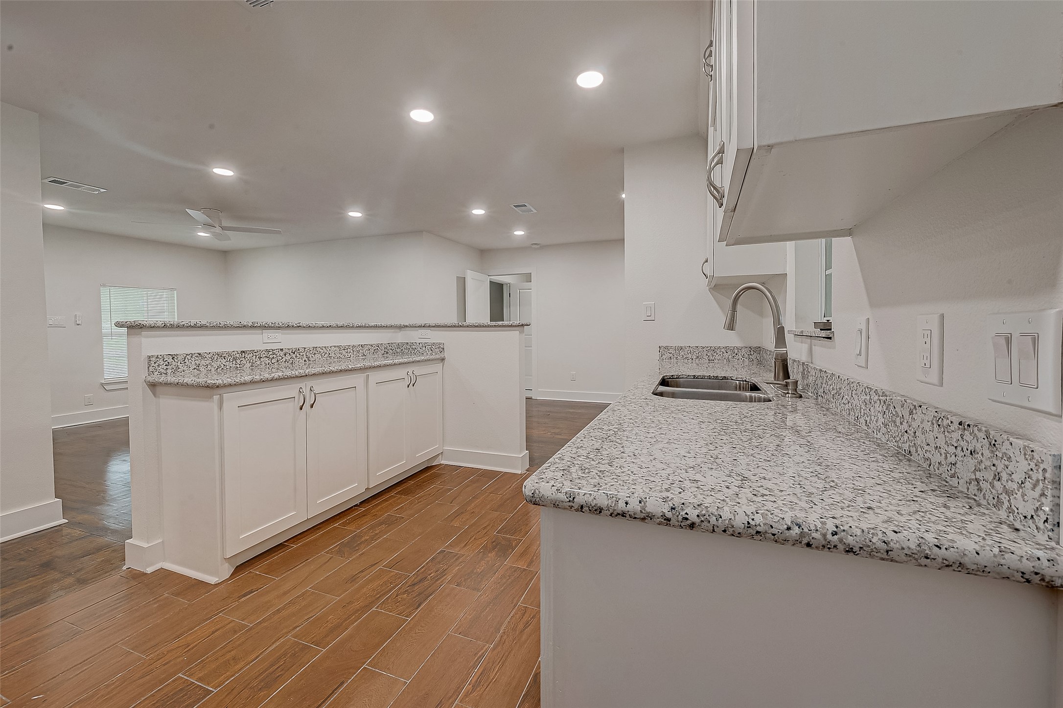 5703 Belmark Street Houston, TX 77033 - Photo 36 of 43 a kitchen with a sink stainless steel appliances and white cabinets