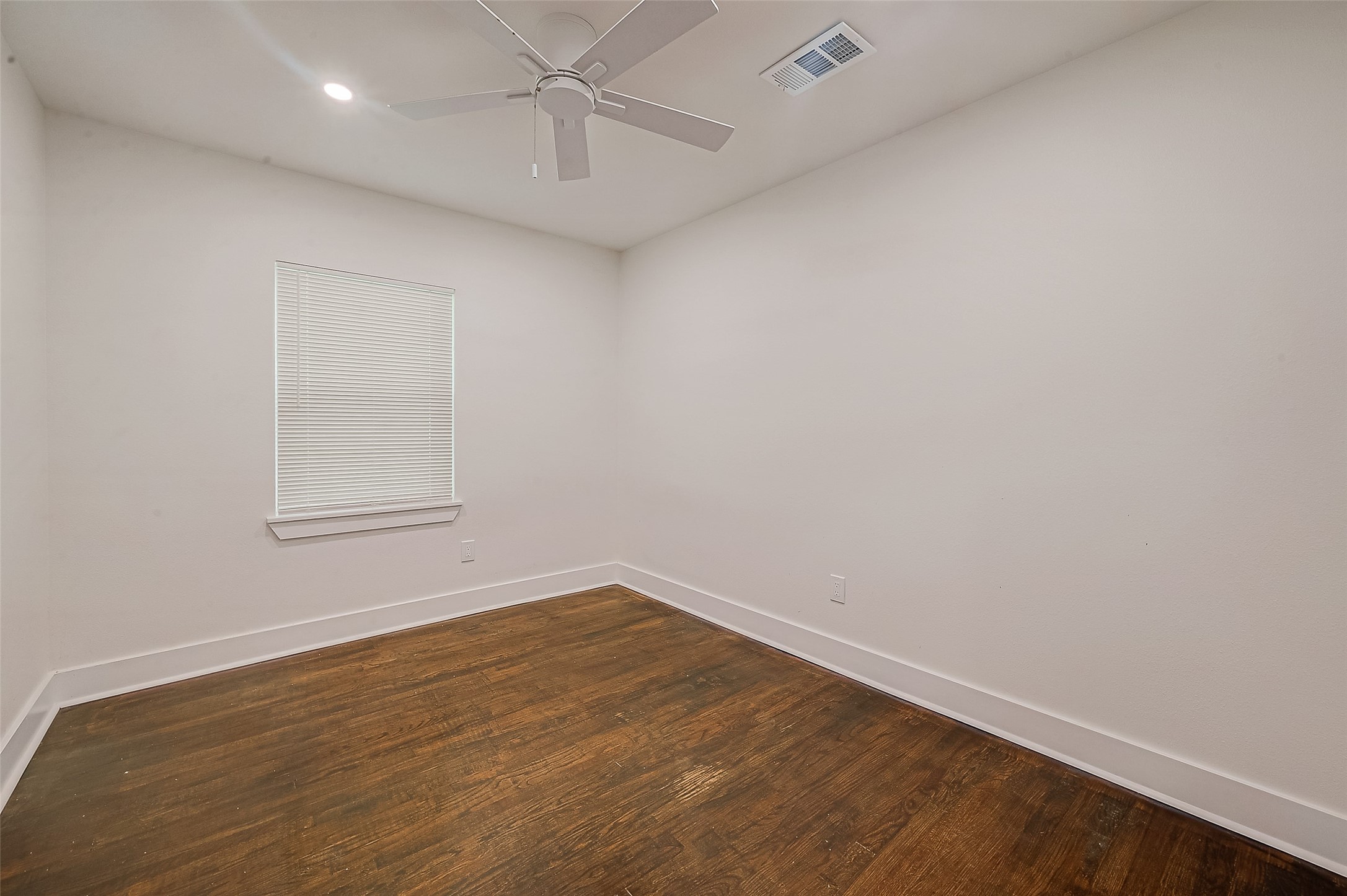 5703 Belmark Street Houston, TX 77033 - Photo 42 of 43 an empty room with wooden floor and windows