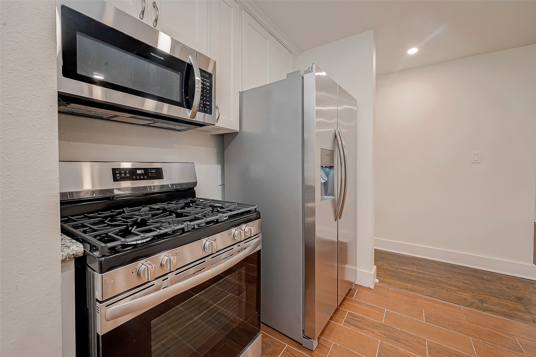 5703 Belmark Street Houston, TX 77033 - Photo 6 of 43 a kitchen with stainless steel appliances granite countertop a stove and a microwave