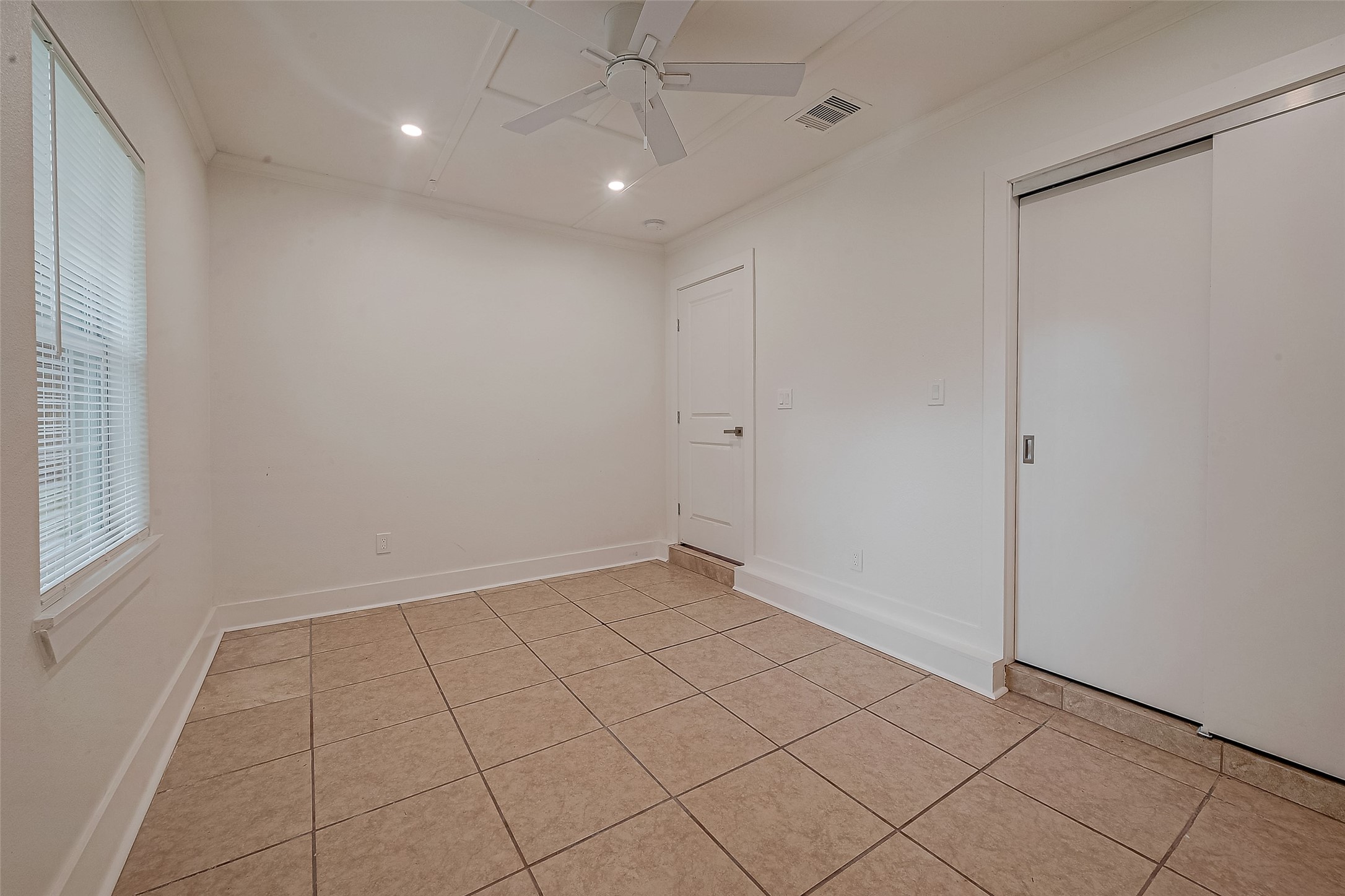 5703 Belmark Street Houston, TX 77033 - Photo 10 of 43 an empty room with white walls and tiles