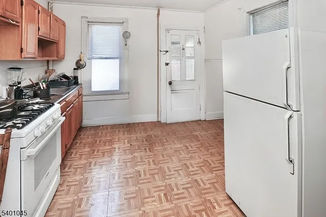 a kitchen with stainless steel appliances a refrigerator a stove a sink and a refrigerator