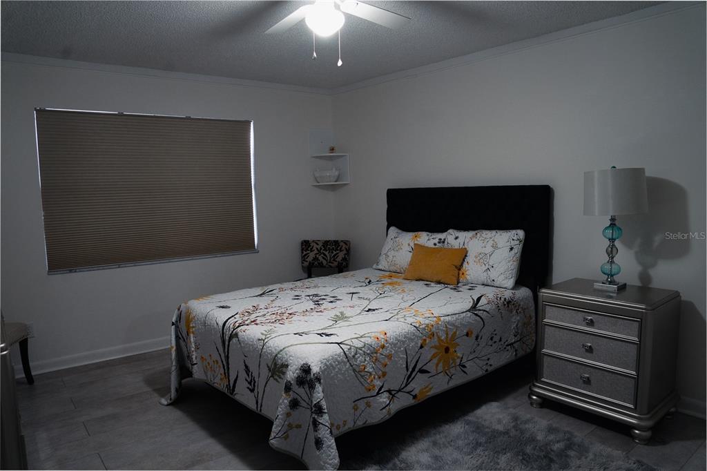 519 Albee Farm Road, Unit 110 Venice, FL 34285 - Photo 15 of 33 a bedroom with a bed and a dresser