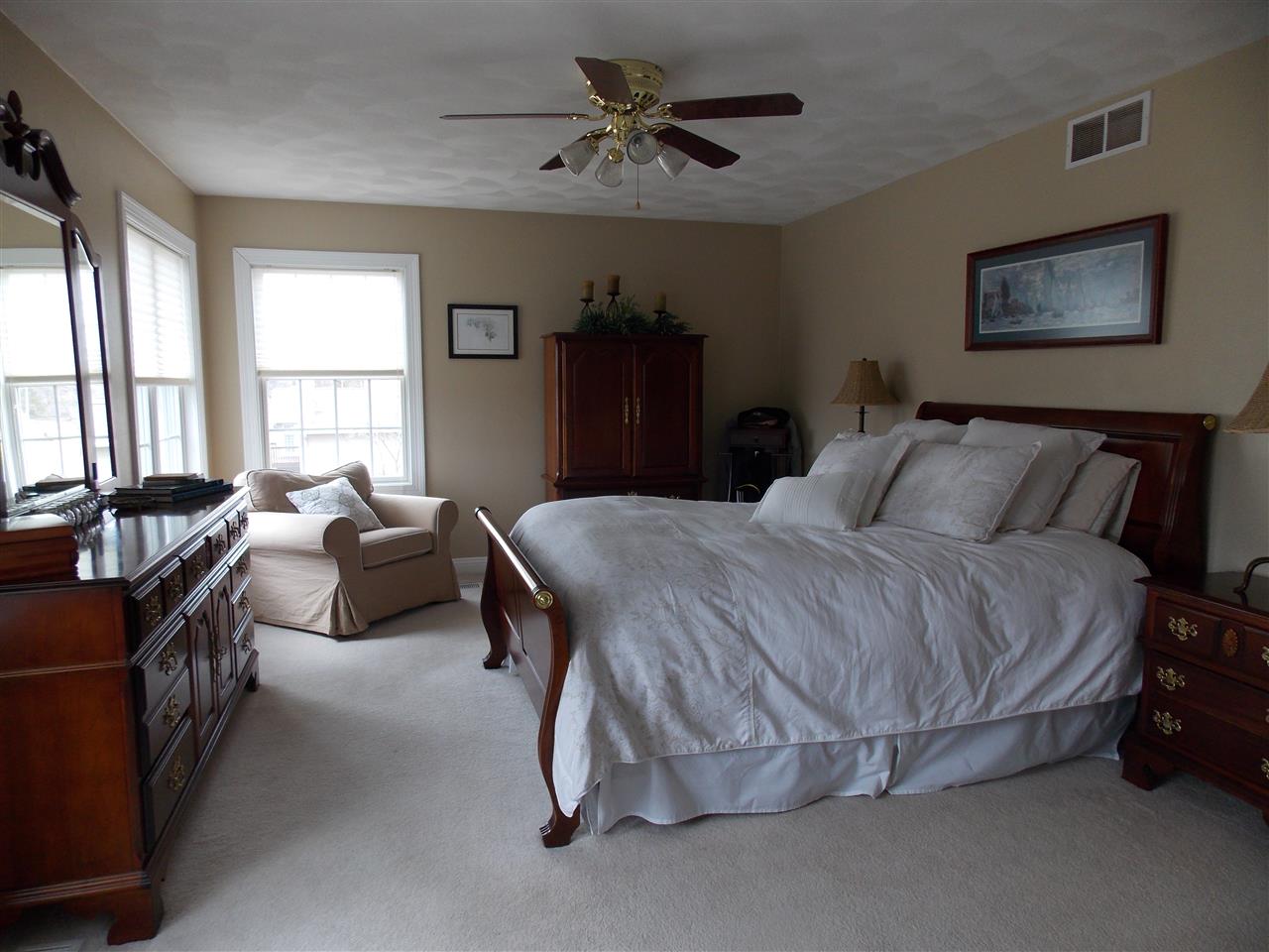4373 Ridgeview Lane Byron, IL 61010 - Photo 15 of 22 a bedroom with a bed and a chandelier