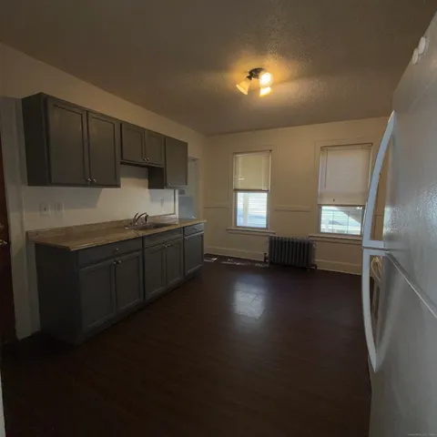 a kitchen with a sink and dishwasher next to a window