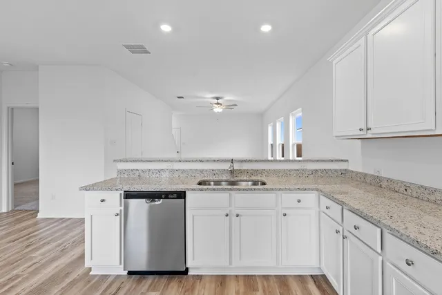 a kitchen with a sink stove and cabinets