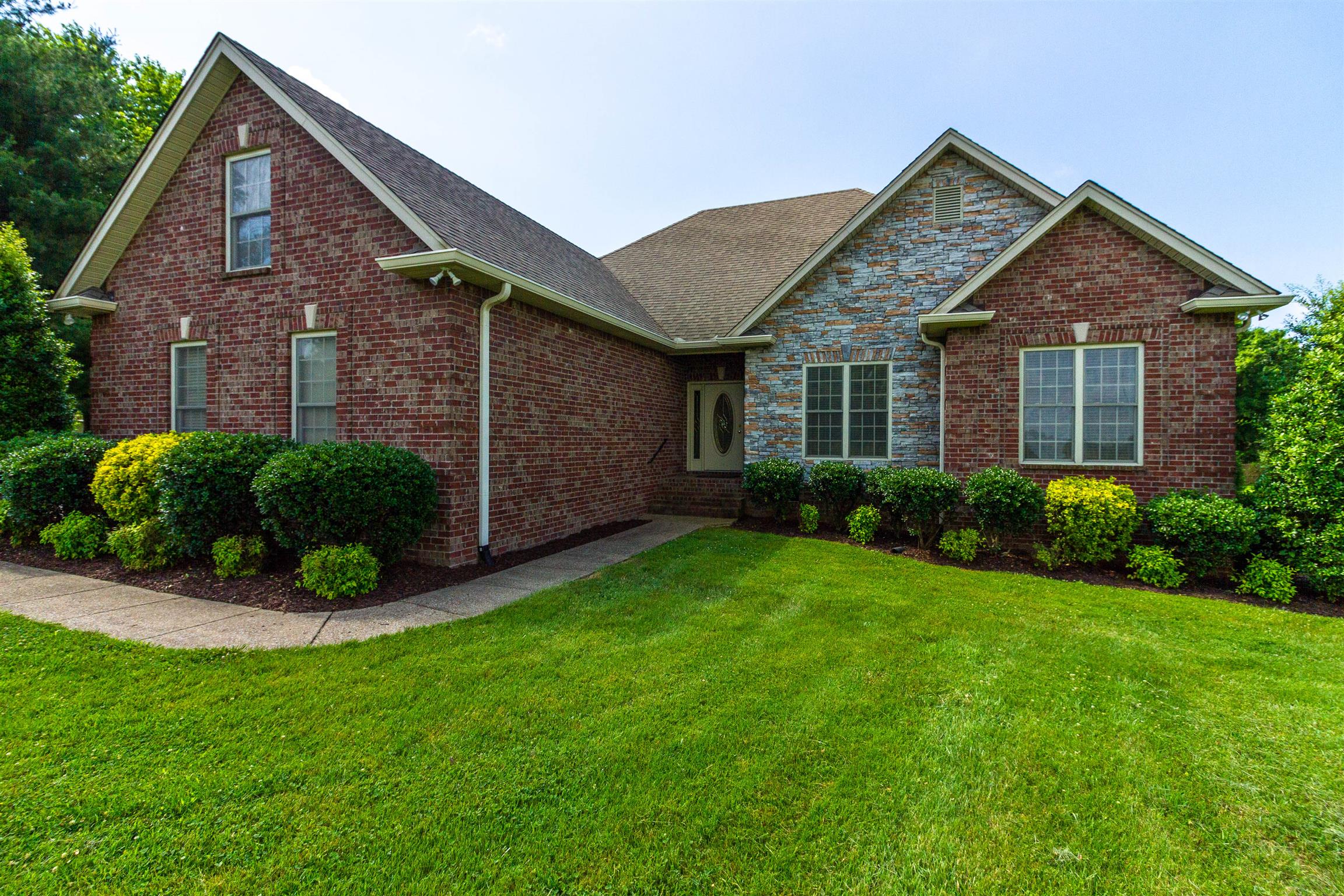 6019 Ebenezer Road Greenbrier, TN 37073 - Photo 1 of 25 a front view of a house with a yard