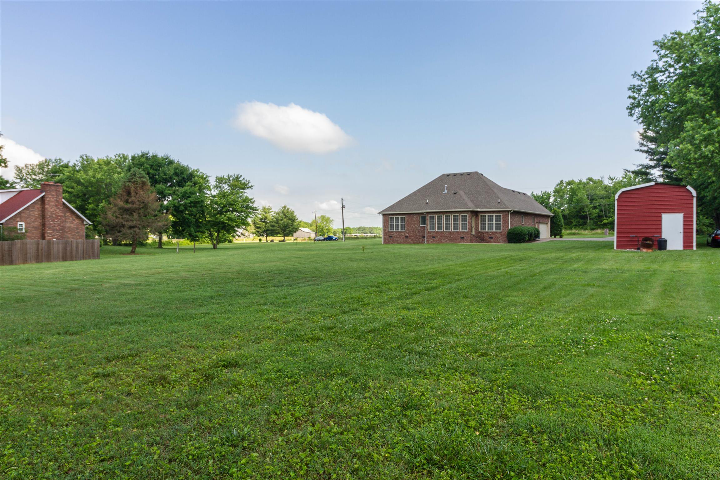6019 Ebenezer Road Greenbrier, TN 37073 - Photo 4 of 25 a view of a big house with a big yard and palm trees