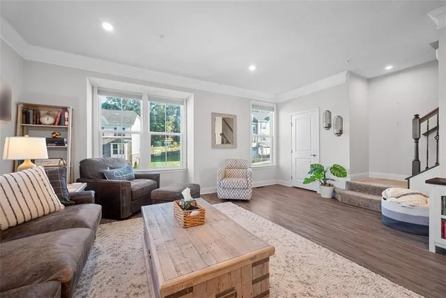 a living room with furniture two window and a table