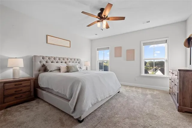 a bedroom with a bed a chandelier and a window