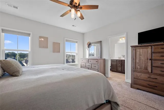 a bedroom with a bed and a television